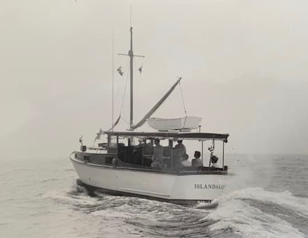Islandside, a classic wooden motor vessel, under way — an old black-and-white photograph